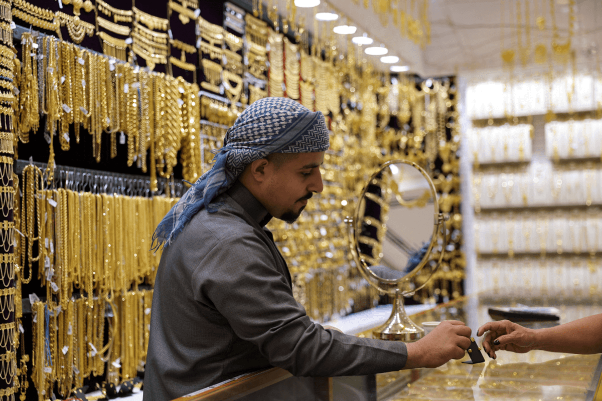 Gold gains on softer dollar