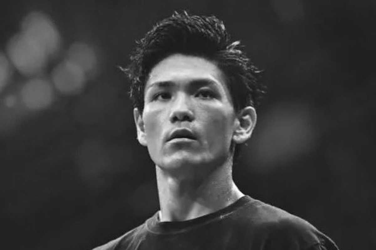 Black and white portrait of a determined man looking upwards.