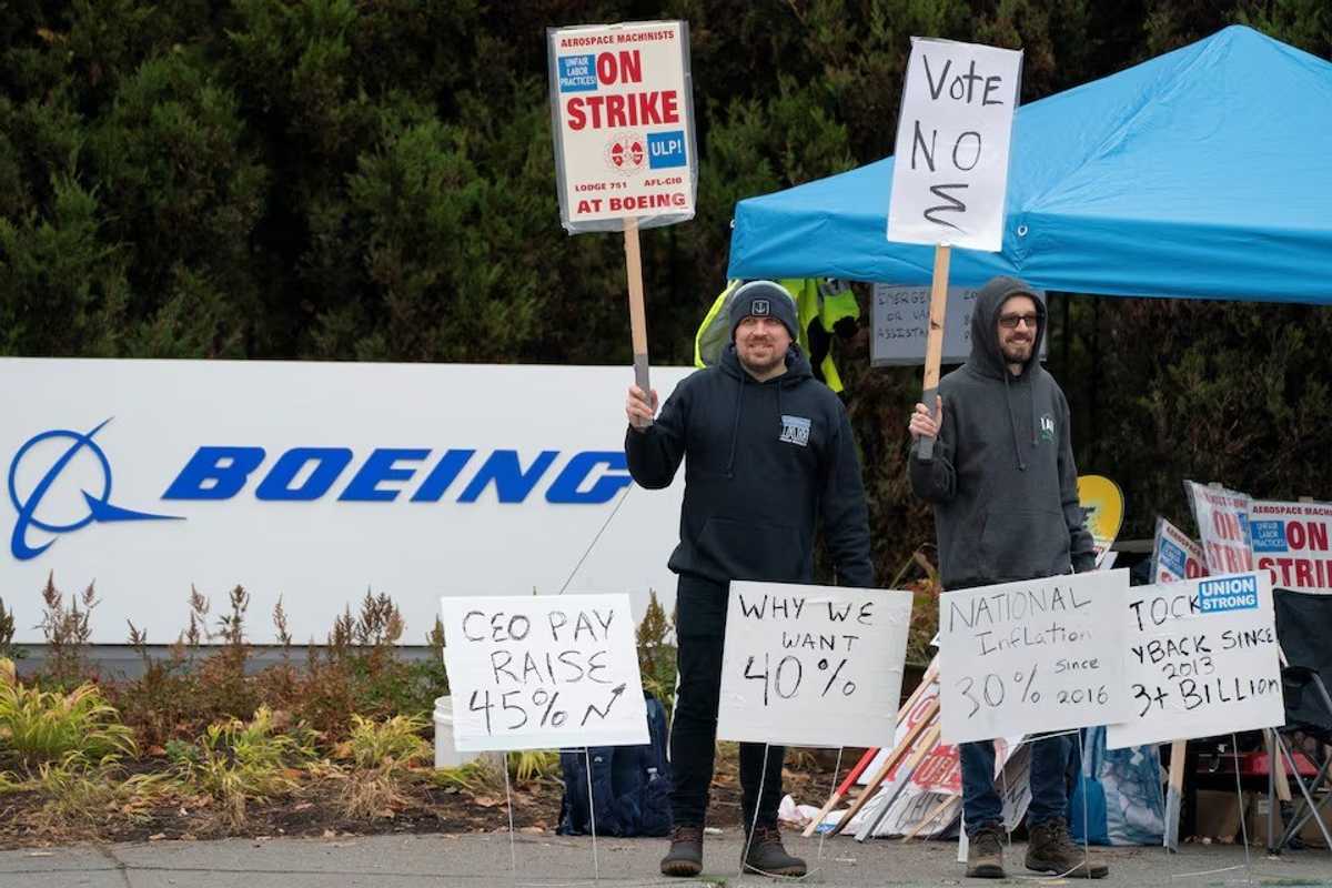 Boeing workers from the International Association of Machinists and Aerospace Workers District 751 gather on a picket line near the entrance to a Boeing production facility on the day of a vote on a new contract proposal during an ongoing strike in Renton, Washington, U.S. October 23, 2024