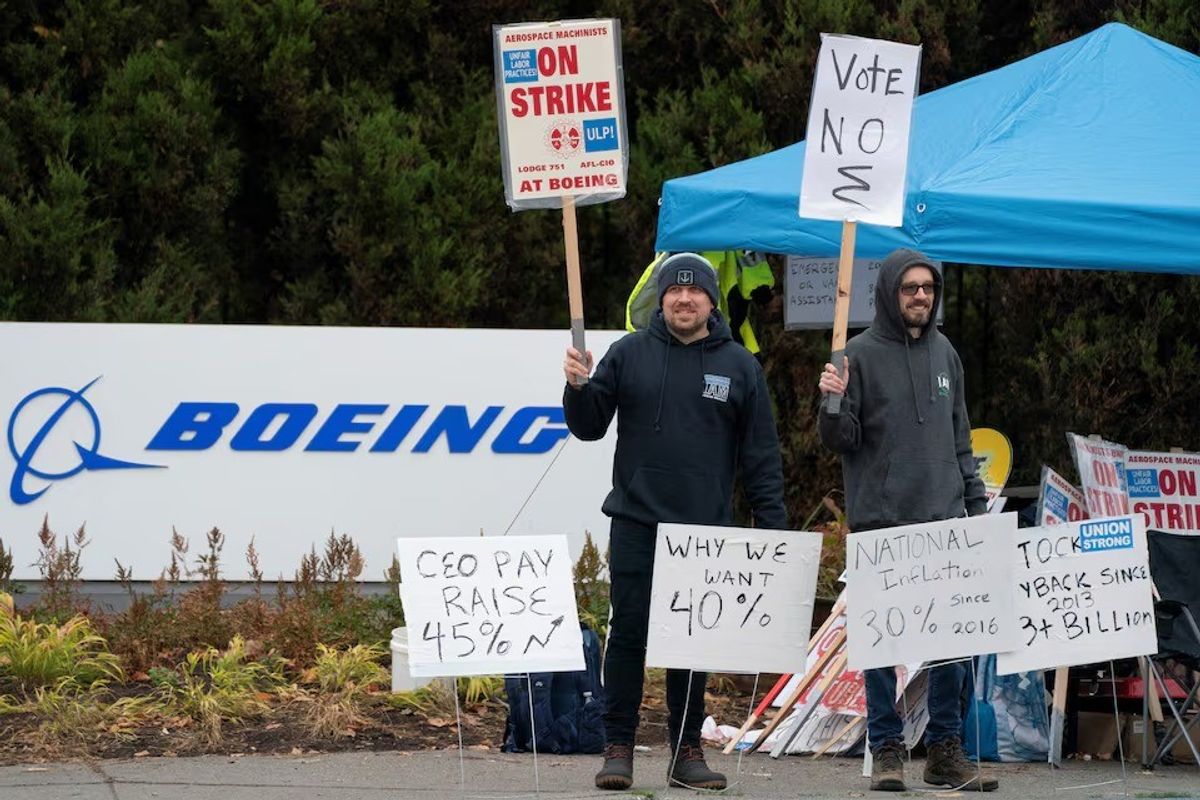 Boeing workers from the International Association of Machinists and Aerospace Workers District 751 gather on a picket line near the entrance to a Boeing production facility on the day of a vote on a new contract proposal during an ongoing strike in Renton, Washington, U.S. October 23, 2024