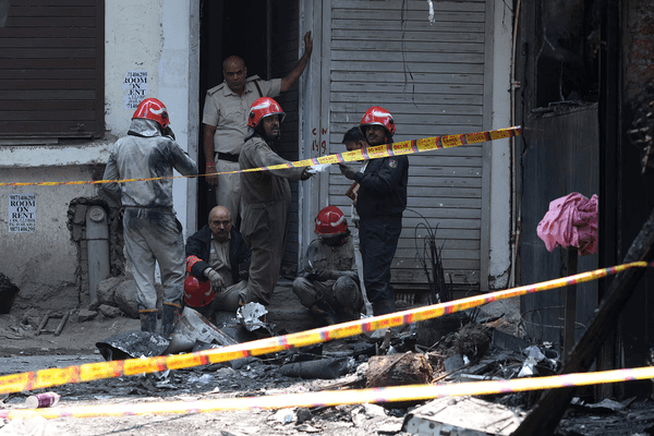 Delhi hotel fire: owner arrested after blaze kills 21, including foreigners