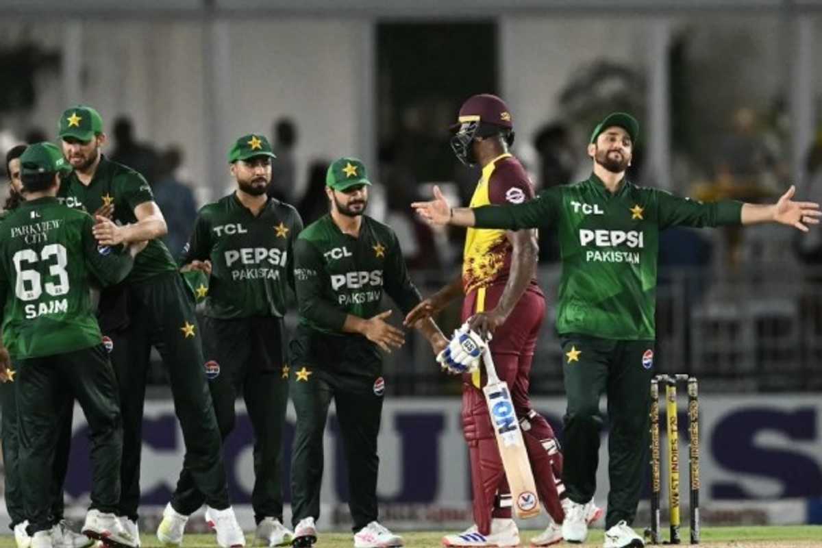Cricket teams shaking hands on the field after a match, wearing green and maroon uniforms.