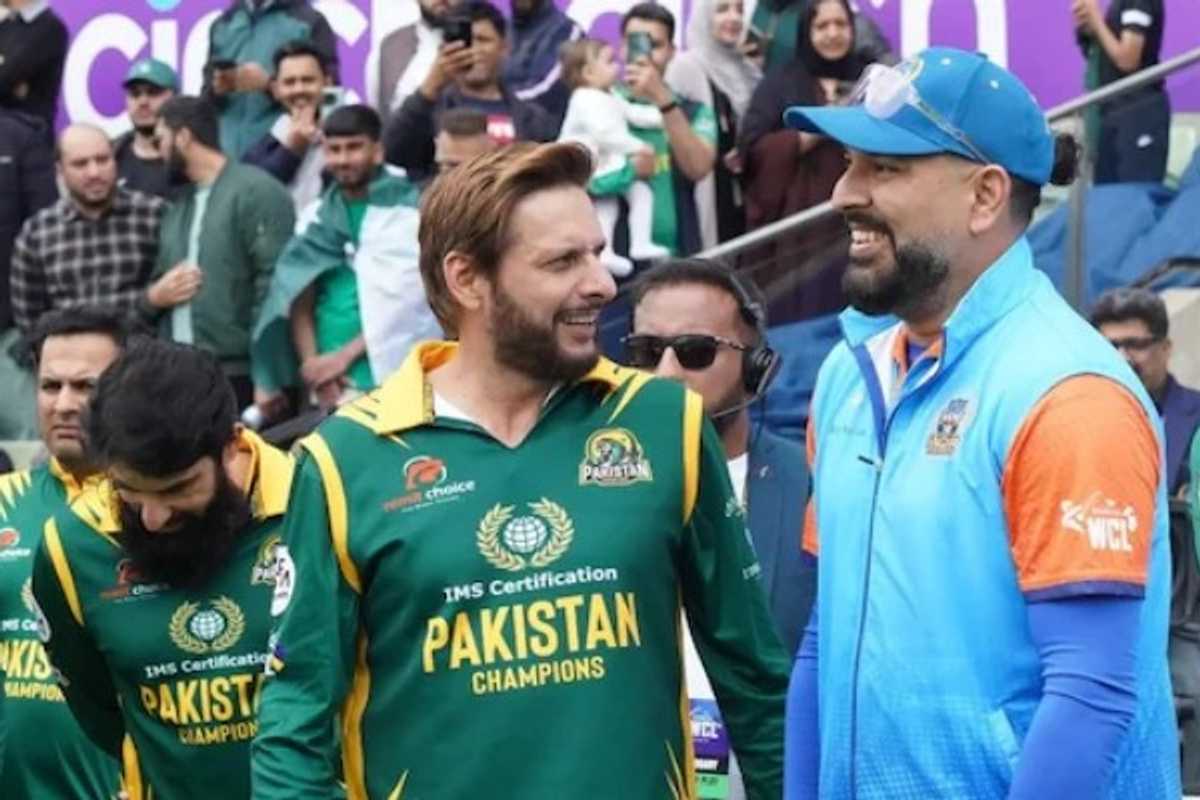 Cricketers in green and blue jerseys smiling, with a crowd in the background.