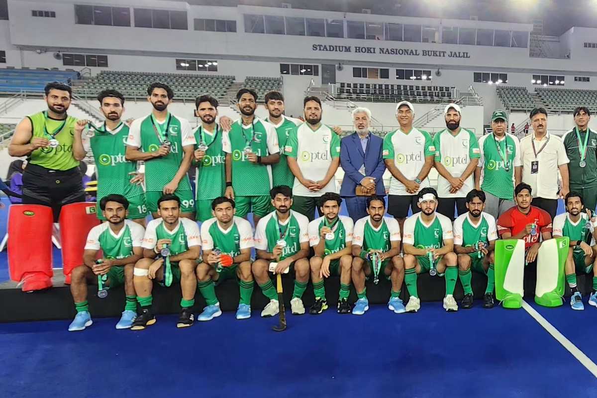 Hockey team poses with medals at Bukit Jalil stadium.