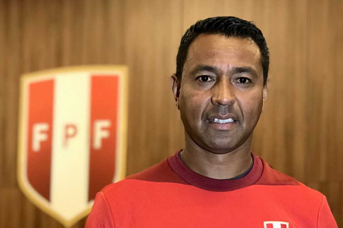 Man in red shirt with FPF logo in background.