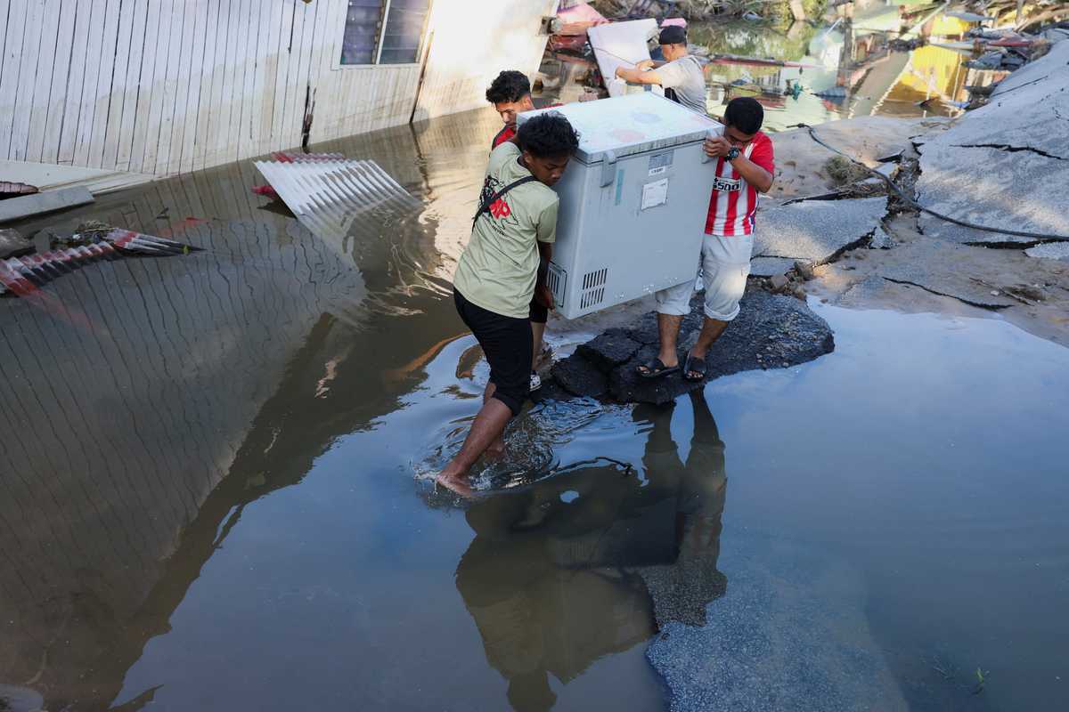 Malaysians return to devastated homes as floodwaters recede; more rain expected