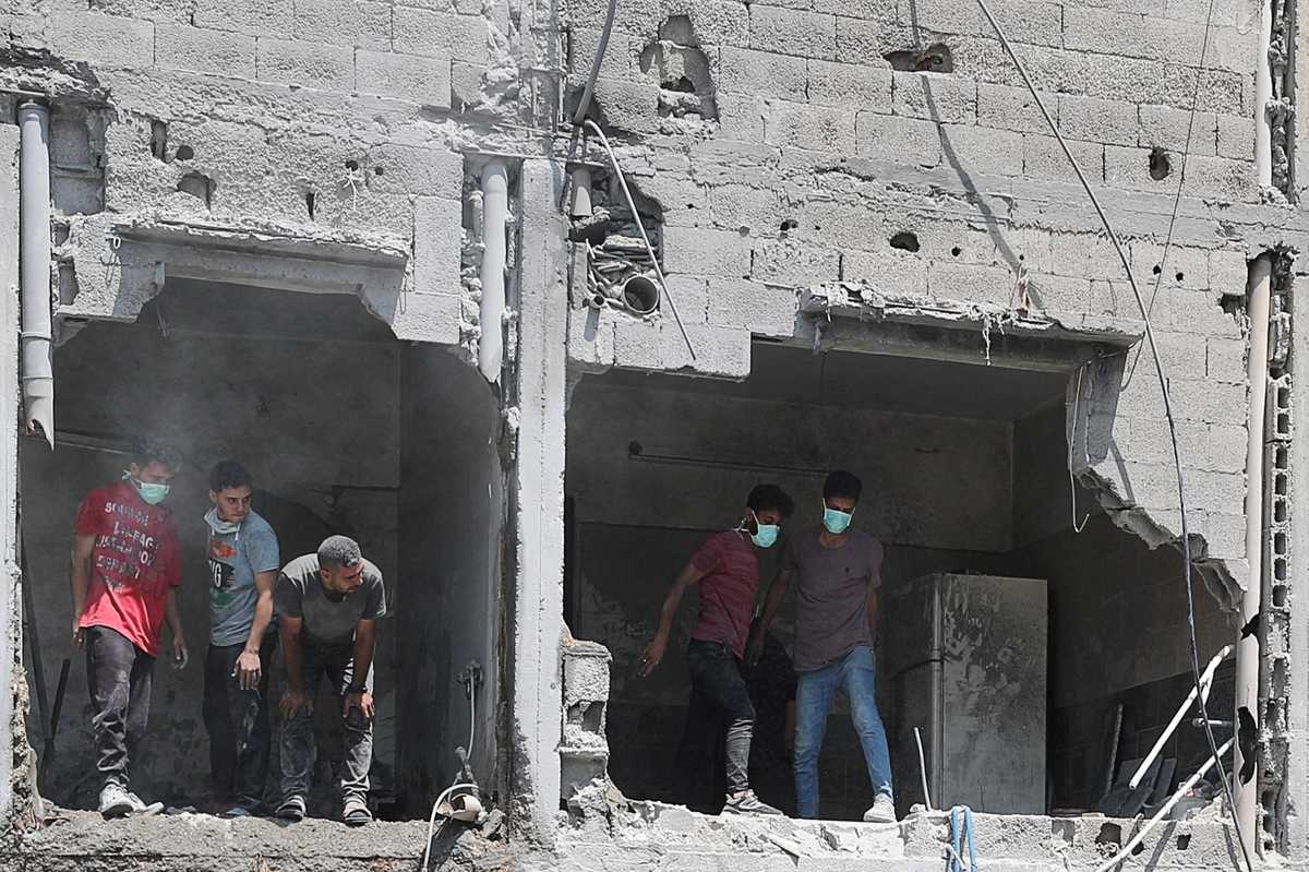 Gaza rescuers say Israeli fire kills 13 including 6 near aid center