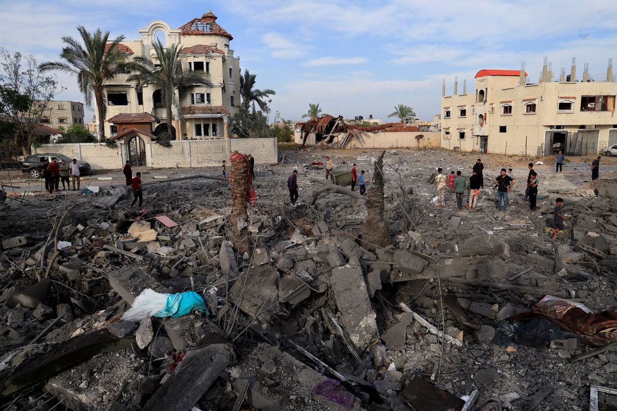 Gaza air strikes kill 94 as manhunt unfolds in West Bank