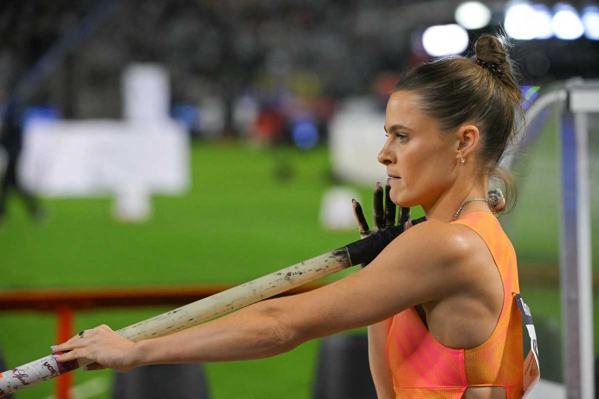 Pole vaulter preparing with focus during a competition.