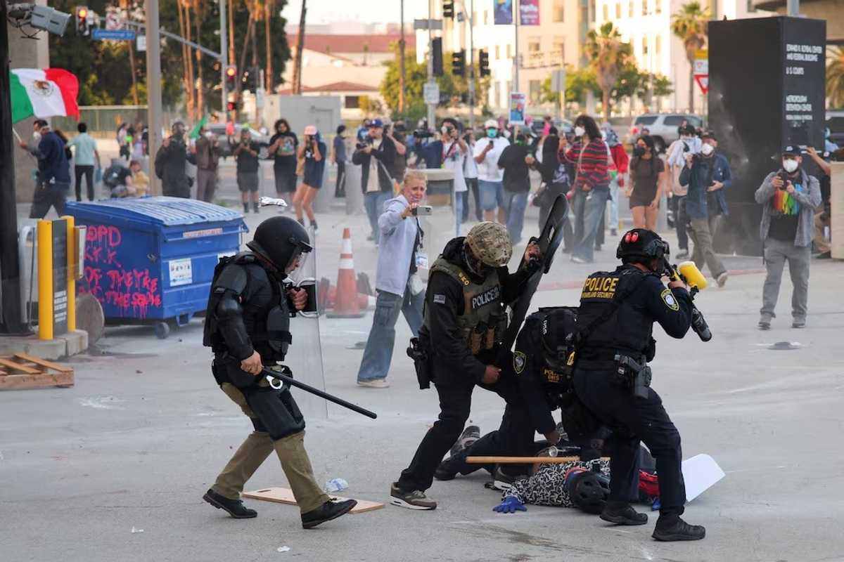 Troops in LA can detain individuals, military official says, as protests spread across US