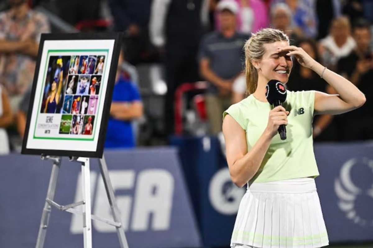 Tennis player smiling and holding a mic beside a framed collage on an easel.