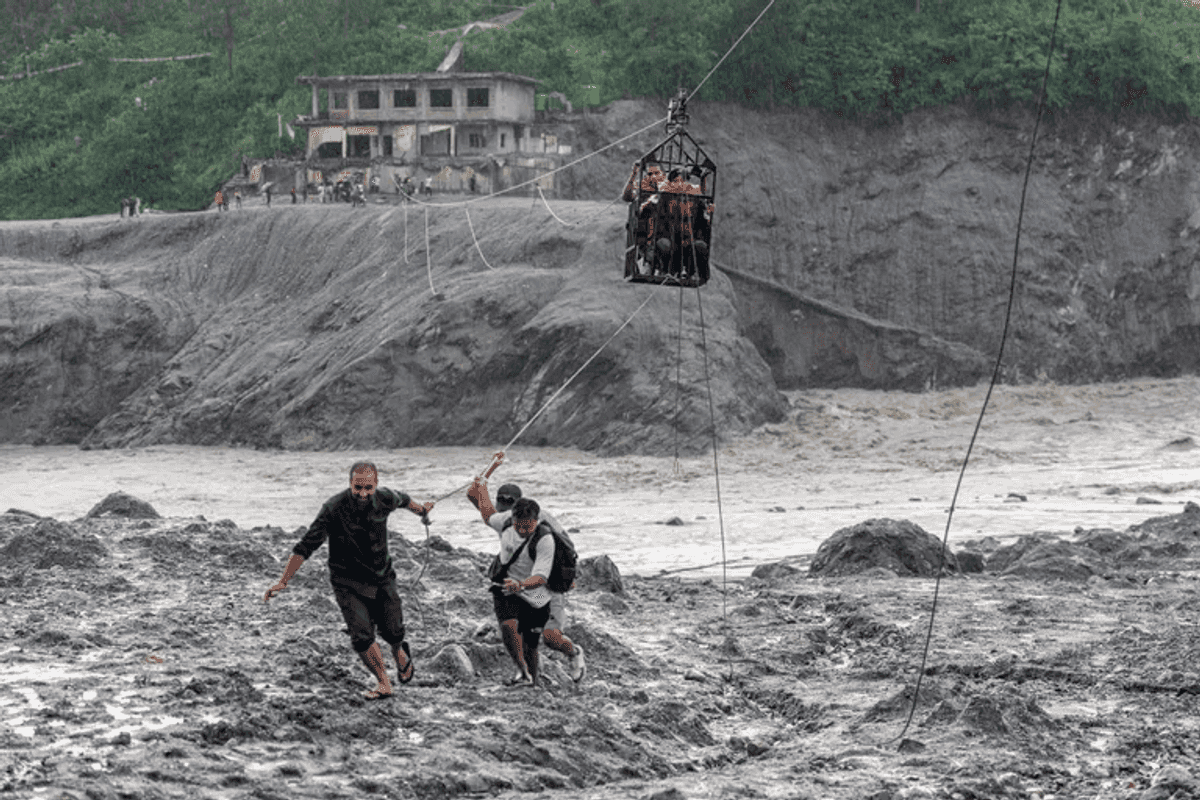 Nepal flood survivors cling to zipline to cross treacherous river