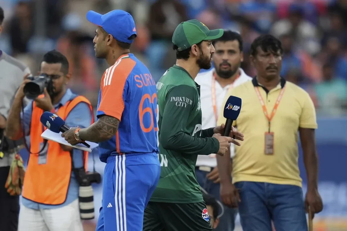 Two cricket players holding microphones during the Asia Cup event.