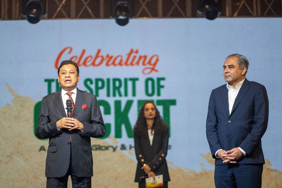 Two men and a woman at a cricket celebration event.